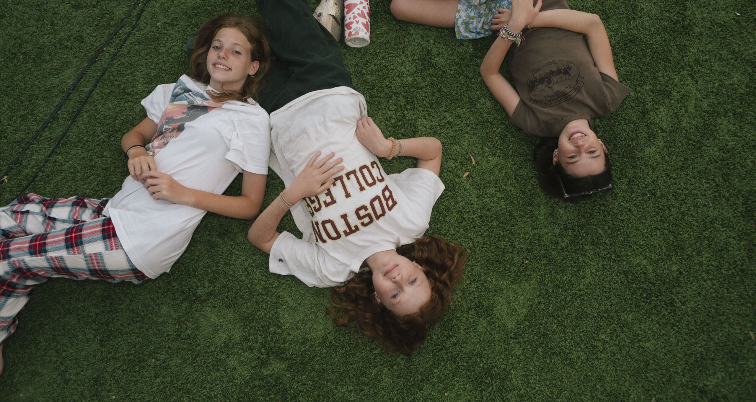 girls laying in the grass