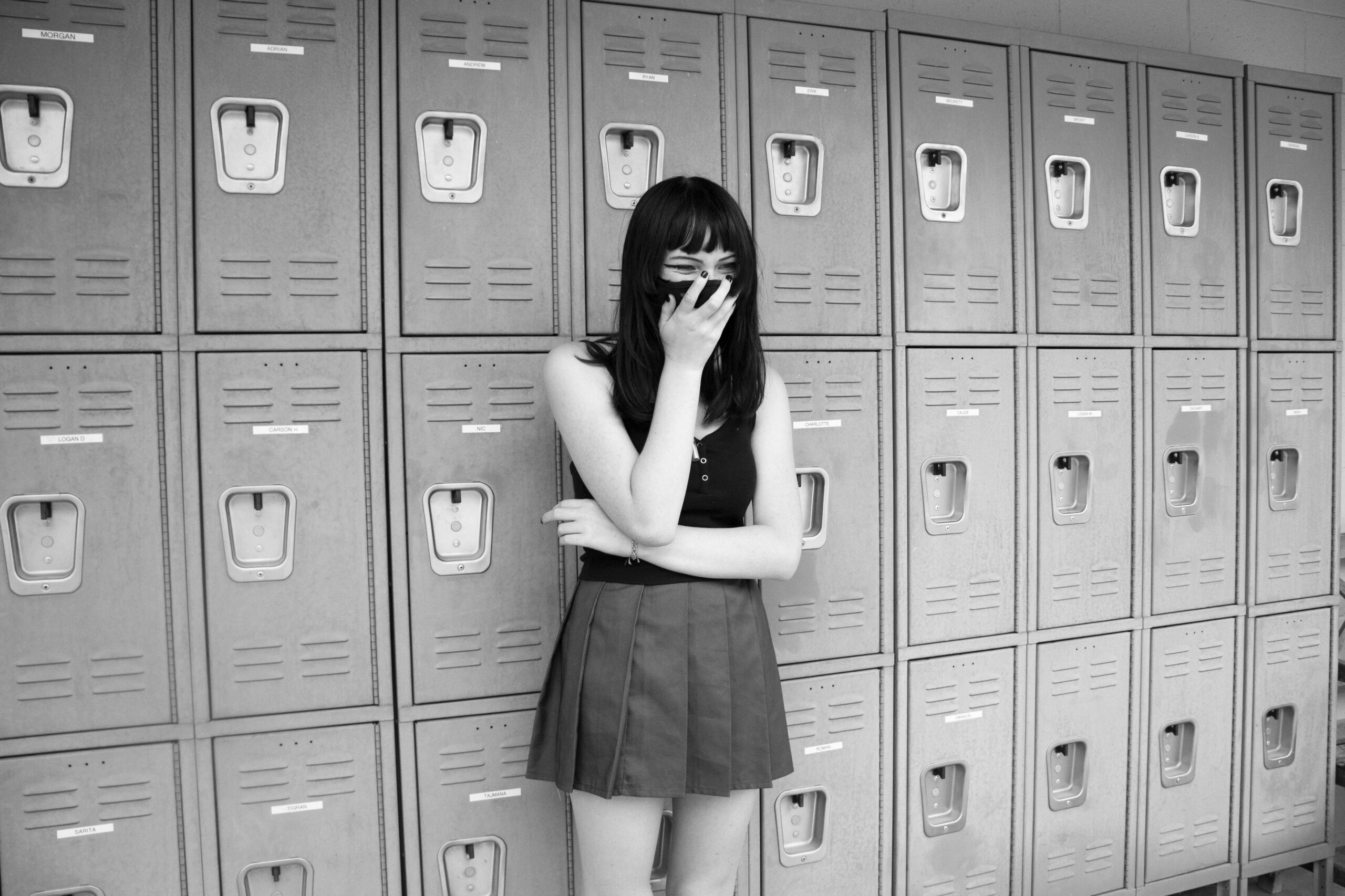 girl standing in front of lockers at school