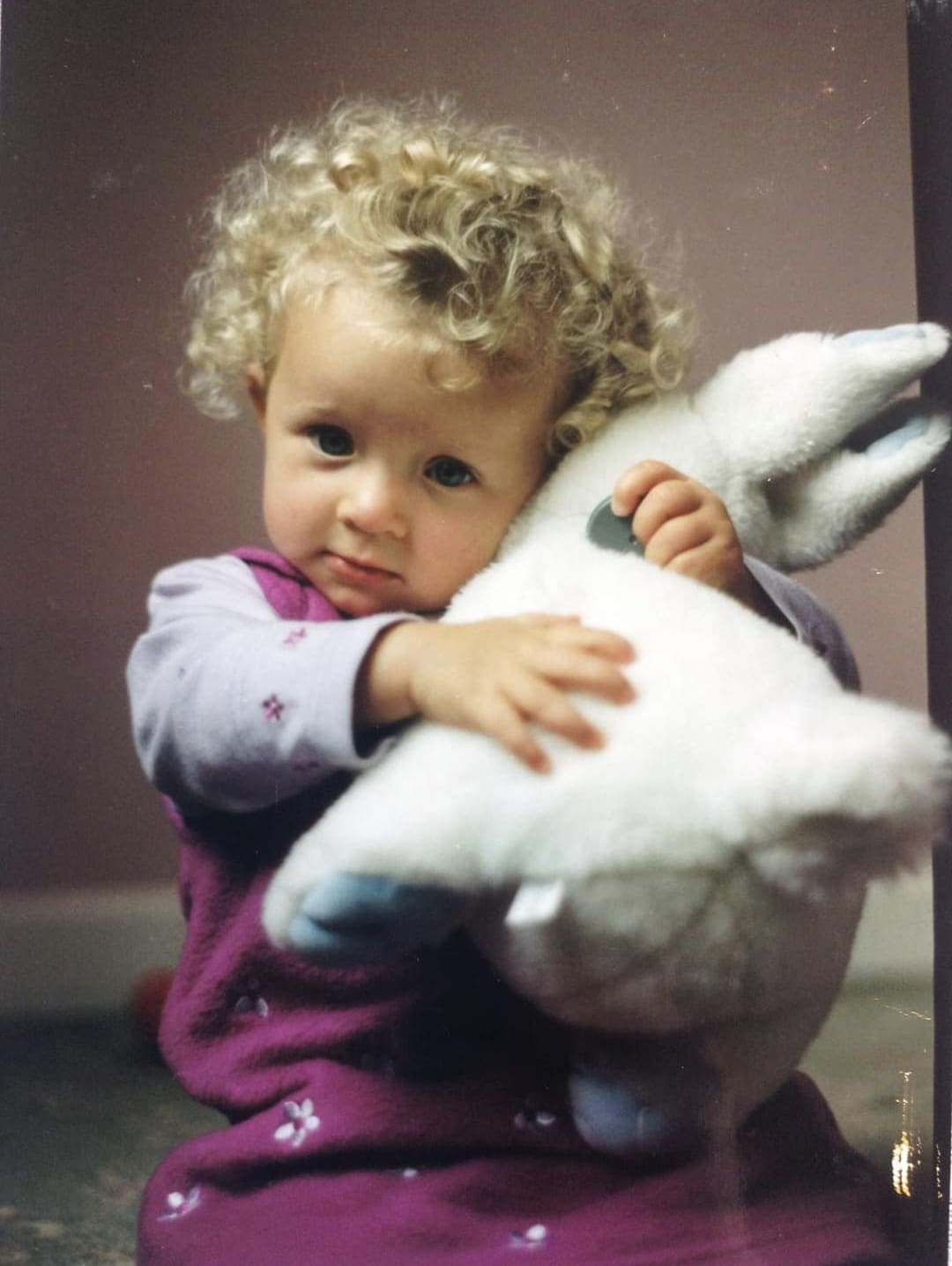baby holding a stuffed animal