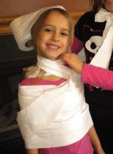 girl covered in toilet paper