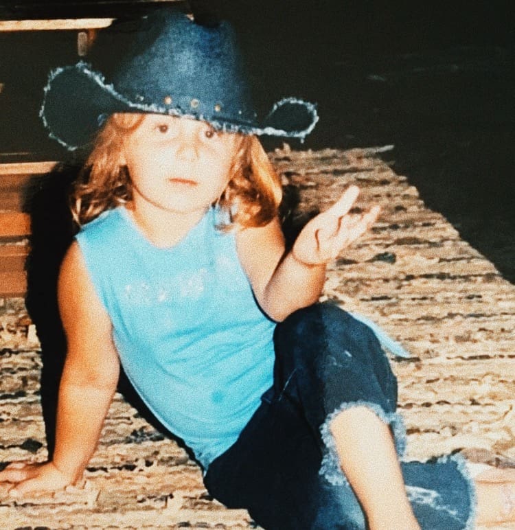 young girl with a cowboy hat on