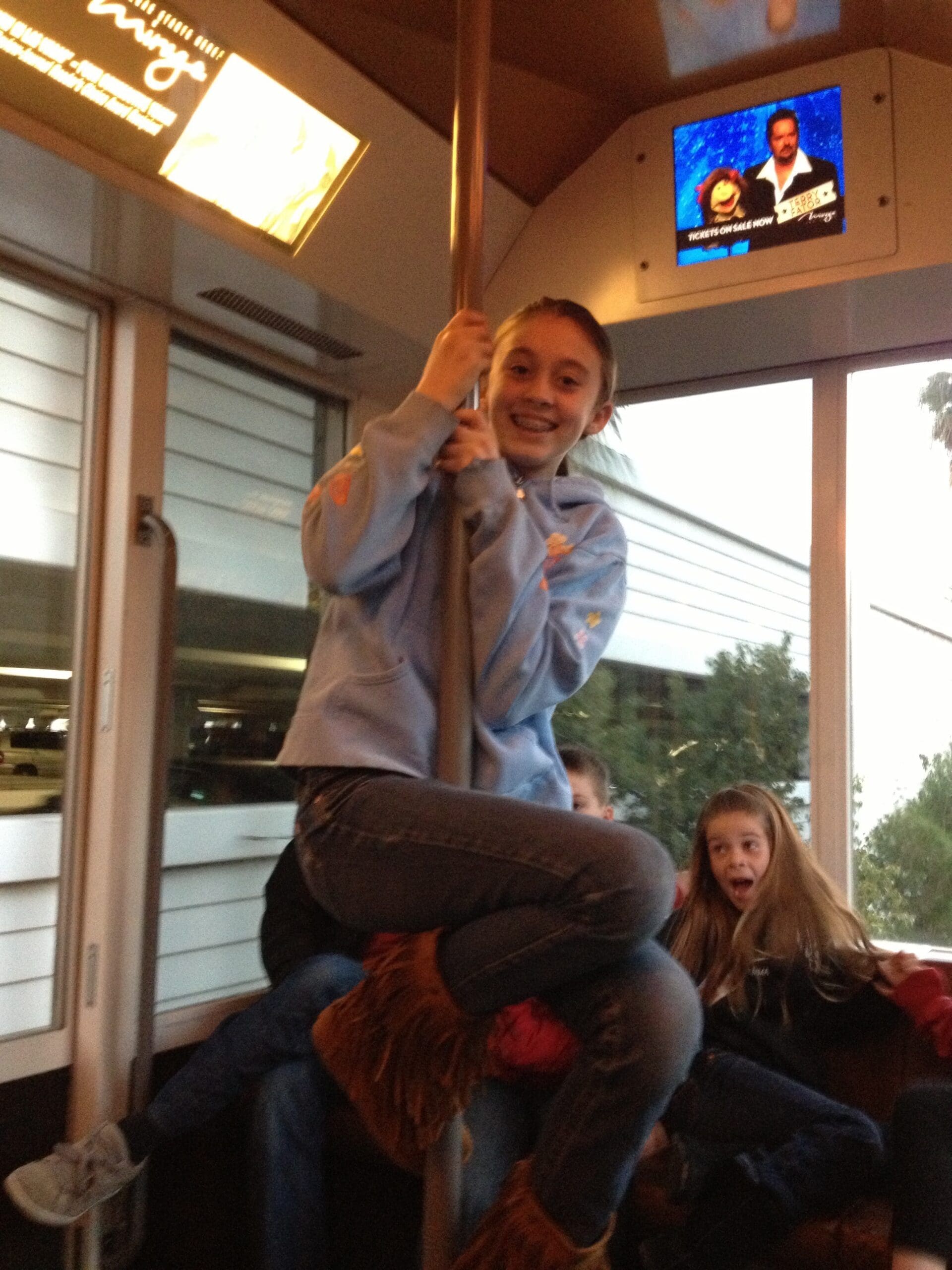 girl on pole on a bus