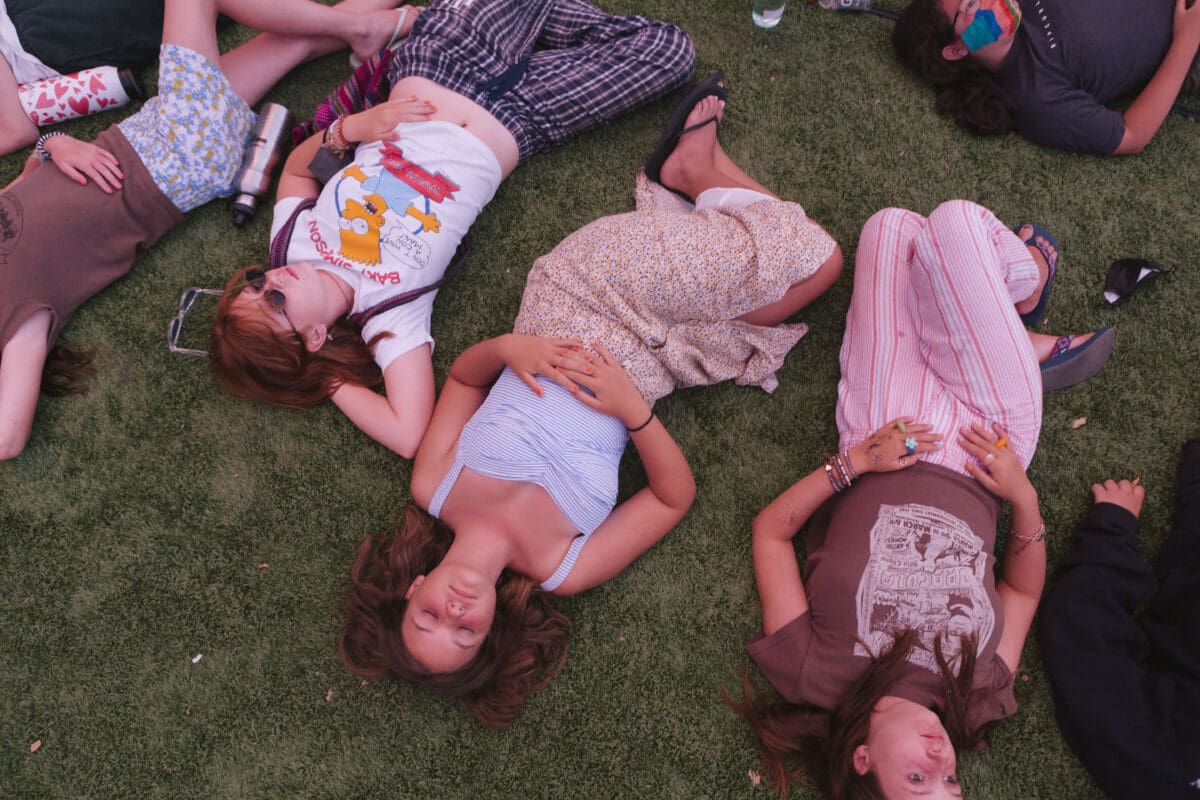 girls laying in the grass